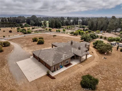 an aerial view of a houses with a beach