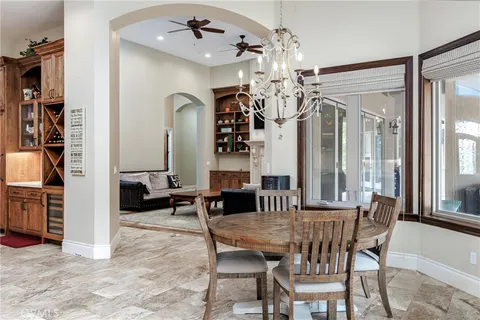 a view of a dining room with furniture and a chandelier