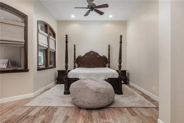 a bedroom with a bed and wooden floor