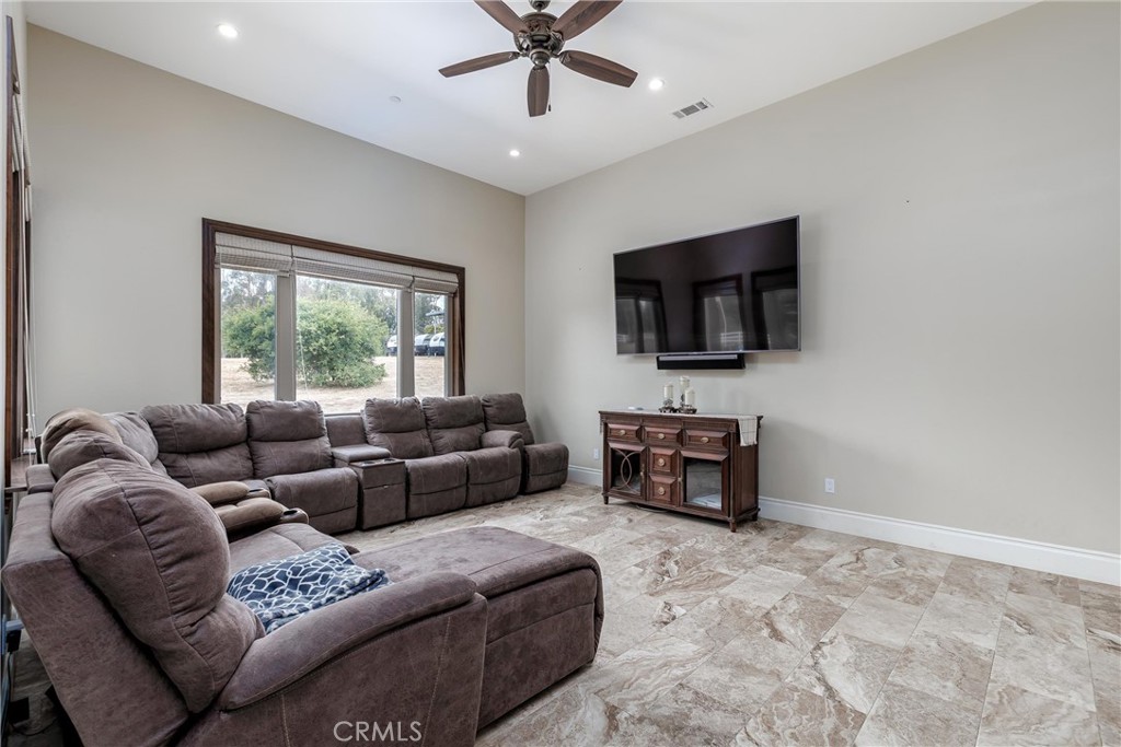 1950 Lemon Ranch Road Arroyo Grande, CA 93420 - Photo 7 of 38 a living room with furniture a flat screen tv and a window