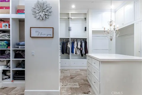 a kitchen with stainless steel appliances a white refrigerator a oven a stove and a refrigerator