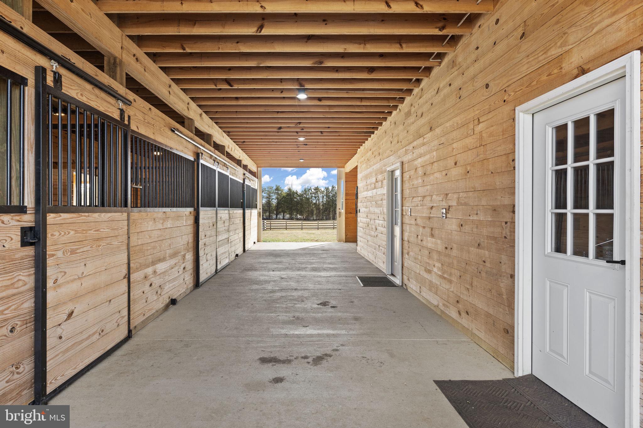 1815 Country Road Beaverdam, VA 23015 - Photo 8 of 98 Barn aisle with custom stalls