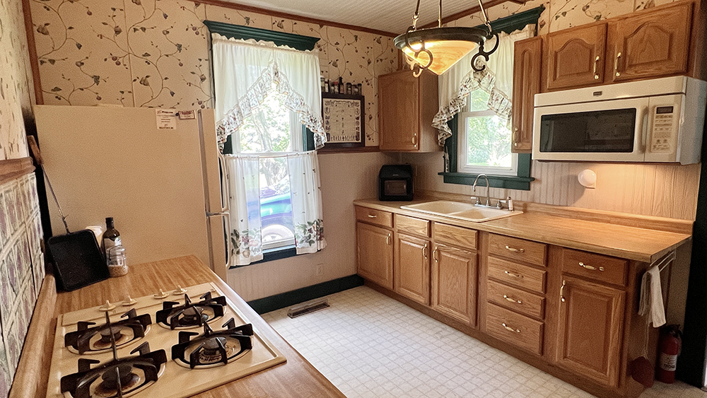 14474 Lyndon Road Morrison, IL 61270 - Photo 17 of 31 a kitchen with stainless steel appliances a stove a microwave and a refrigerator