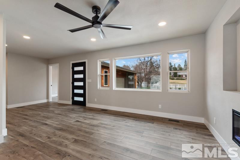995 Skyline Boulevard Reno, NV 89509 - Photo 3 of 34 a view of an empty room with a window and wooden floor