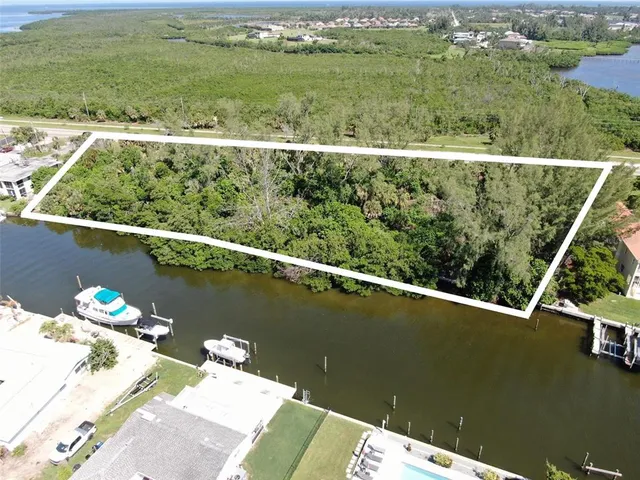 an aerial view of a residential houses with outdoor space and city view