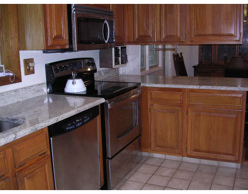 19 Larnis Road Framingham, MA 01701 - Photo 8 of 13 a kitchen with granite countertop a stove top oven microwave and cabinets