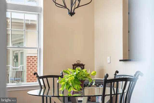 a living room with a dining table and a rug