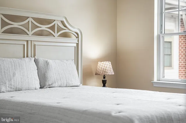 a bedroom with a bed and a window