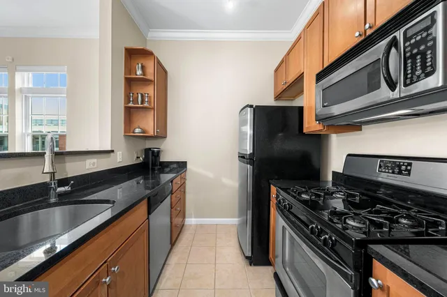 a kitchen with stainless steel appliances granite countertop a stove and a microwave