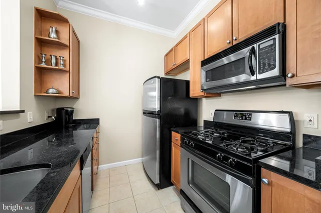 a kitchen with granite countertop a stove and a sink