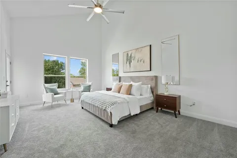 a spacious bedroom with a bed and a window