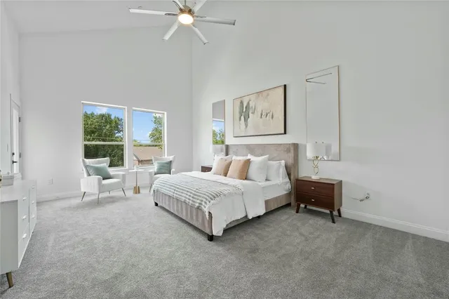 a spacious bedroom with a bed and a window