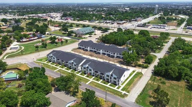 an aerial view of residential houses with outdoor space