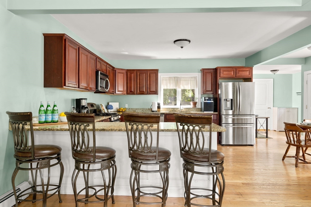 109 Read Street Somerset, MA 02726 - Photo 14 of 42 a kitchen with stainless steel appliances granite countertop a table chairs and a refrigerator