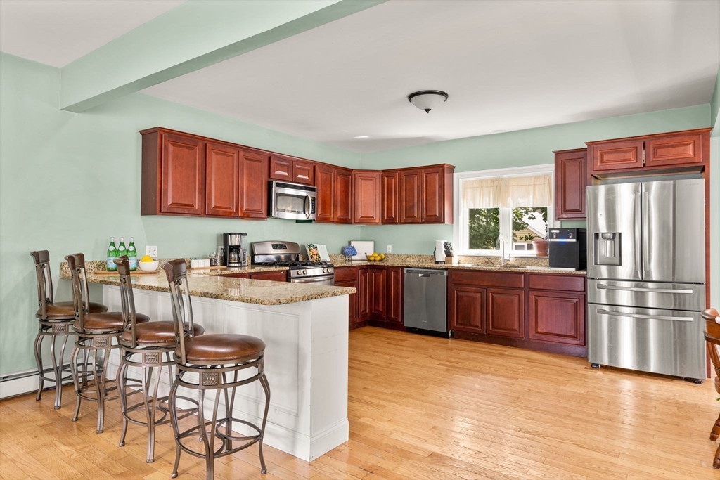 109 Read Street Somerset, MA 02726 - Photo 15 of 42 a kitchen with stainless steel appliances granite countertop a refrigerator sink and wooden cabinets