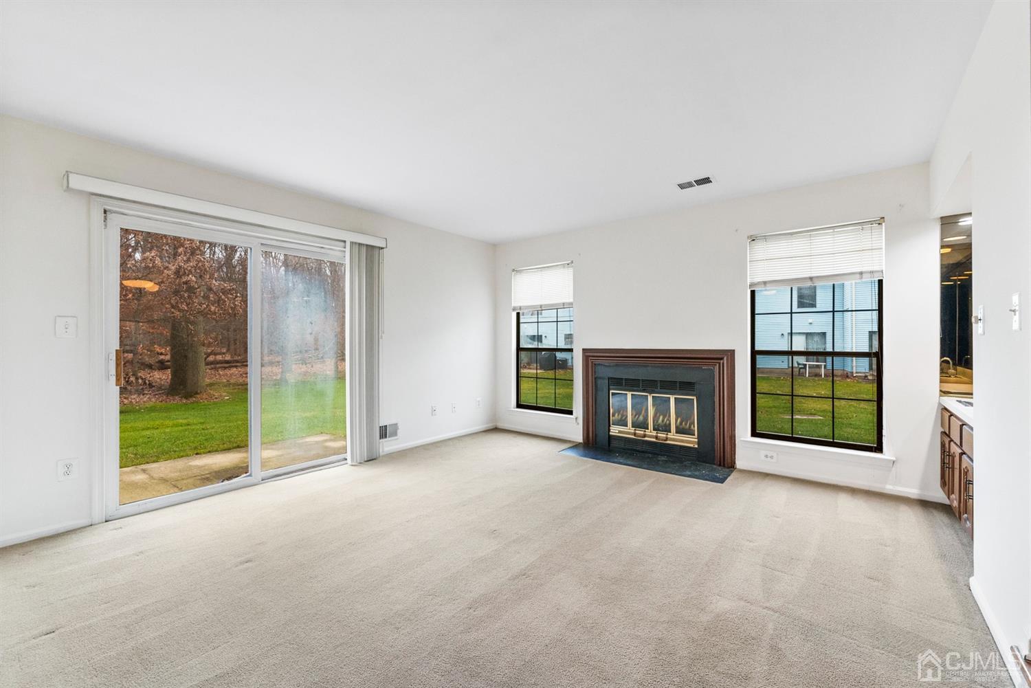 3708 Cricket Circle Edison, NJ 08820 - Photo 16 of 40 a view of an empty room with a fireplace and a window