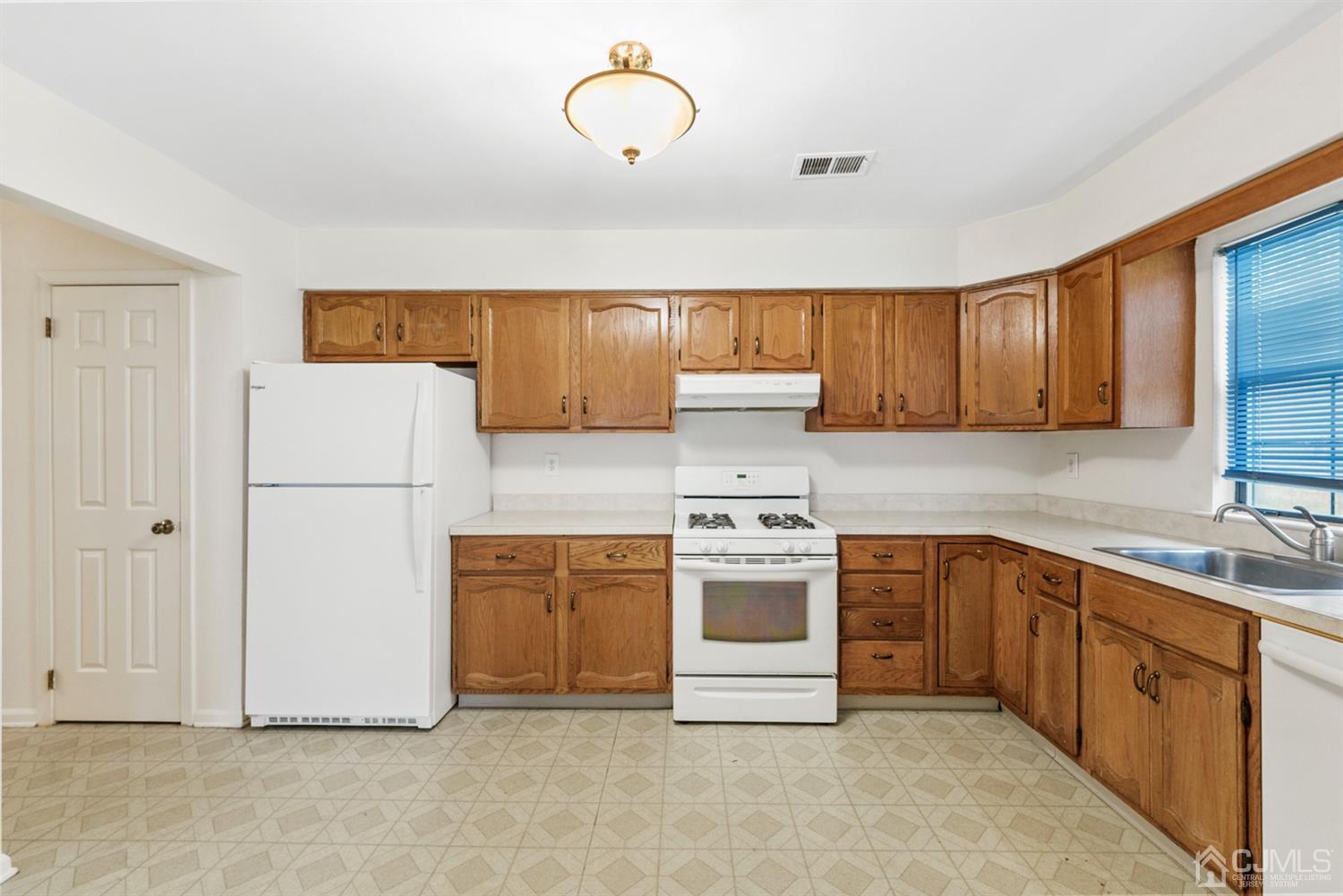 3708 Cricket Circle Edison, NJ 08820 - Photo 10 of 40 a kitchen with sink a refrigerator and cabinets