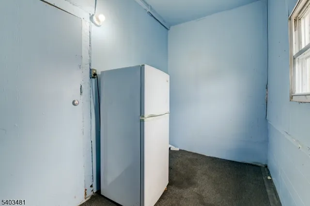 a kitchen with a refrigerator a stove top oven a sink and cabinets