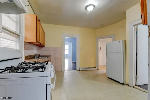 a kitchen with a stove and a refrigerator