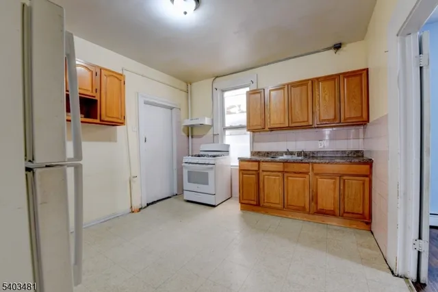 a kitchen with stainless steel appliances a refrigerator and a stove top oven