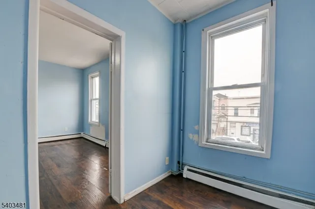 a view of a room with wooden floor and a window