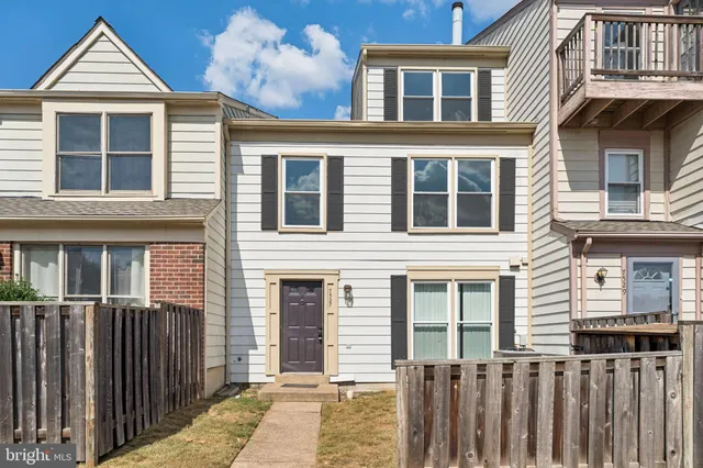 a view of a brick house with large windows