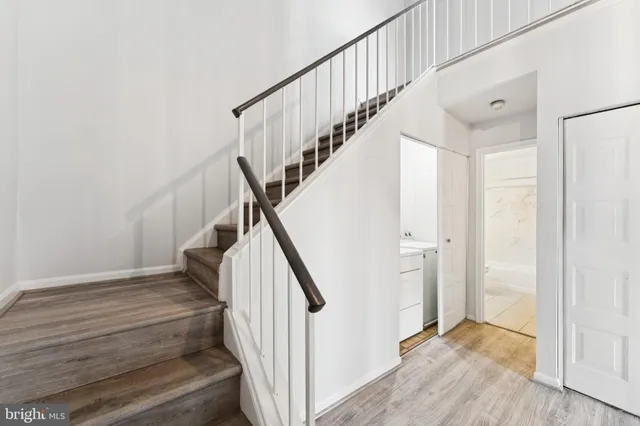 a view of a hallway with wooden floor and entryway