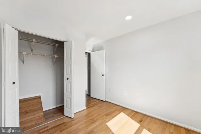 a view of an empty room and wooden floor