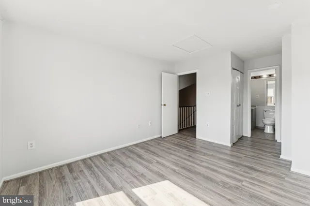 a view of an empty room and wooden floor