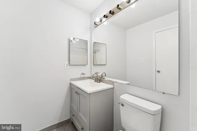 a bathroom with a toilet sink and mirror