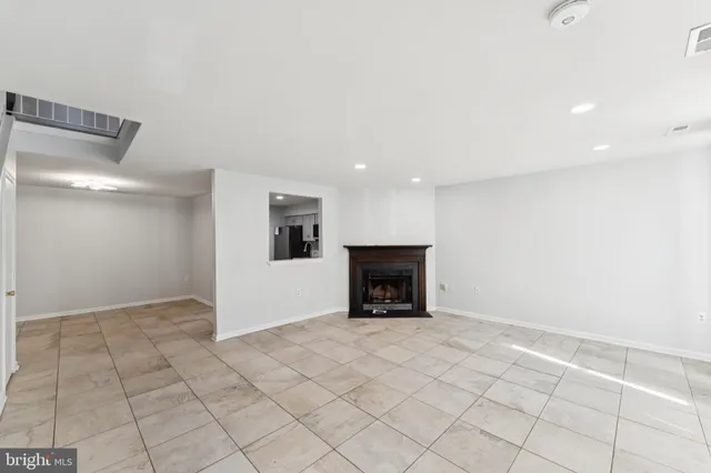 a view of an empty room with a fireplace