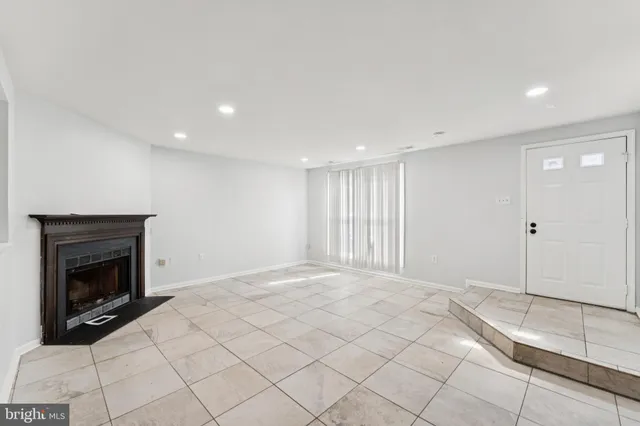 a view of an empty room with a fireplace