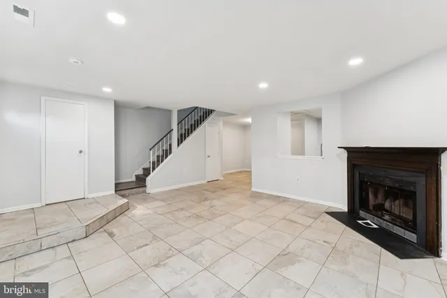 a view of an empty room with a fireplace