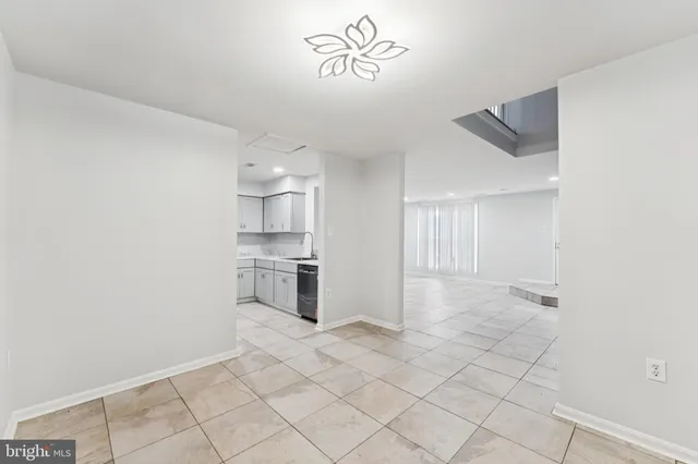 a view of a kitchen with a sink and a refrigerator