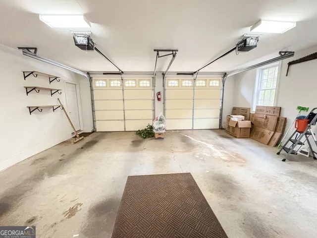 a view of a house with wooden fence next to a yard
