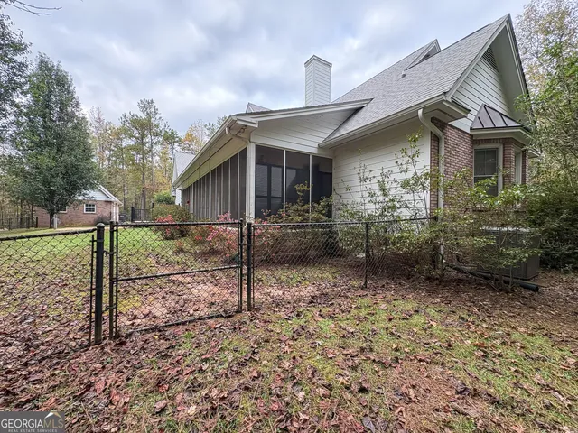 a view of yard with swimming pool and trees in the background