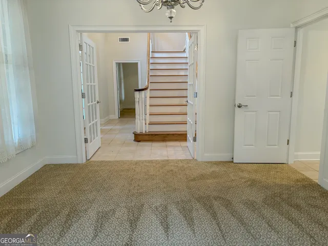 a view of an empty room and a window
