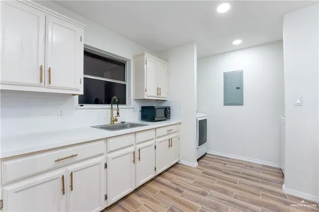 a kitchen with sink cabinets and window