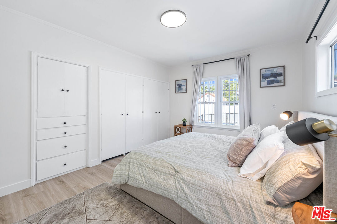 140 North Carson Road Beverly Hills, CA 90211 - Photo 12 of 28 a bedroom with a bed and a window