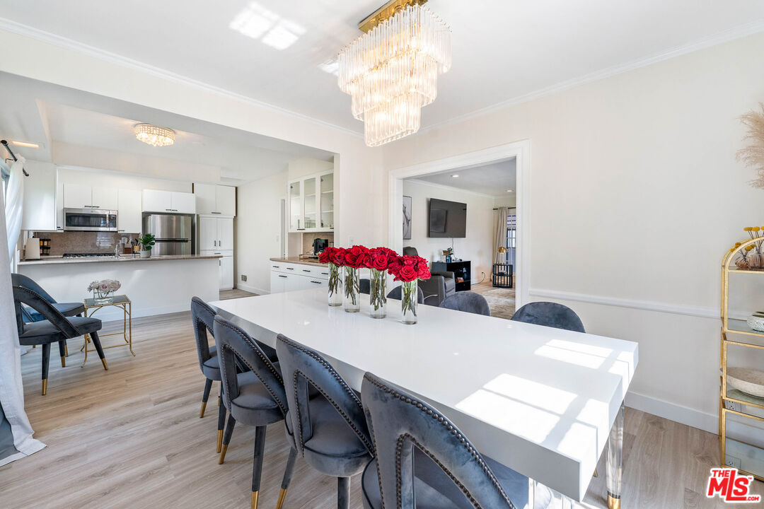 140 North Carson Road Beverly Hills, CA 90211 - Photo 2 of 28 a view of a dining room with furniture and wooden floor