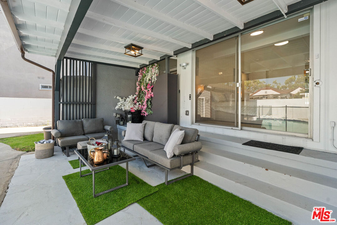140 North Carson Road Beverly Hills, CA 90211 - Photo 24 of 28 a living room with furniture and a large window