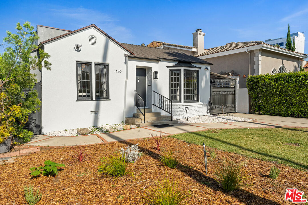 140 North Carson Road Beverly Hills, CA 90211 - Photo 27 of 28 a front view of a house with a yard