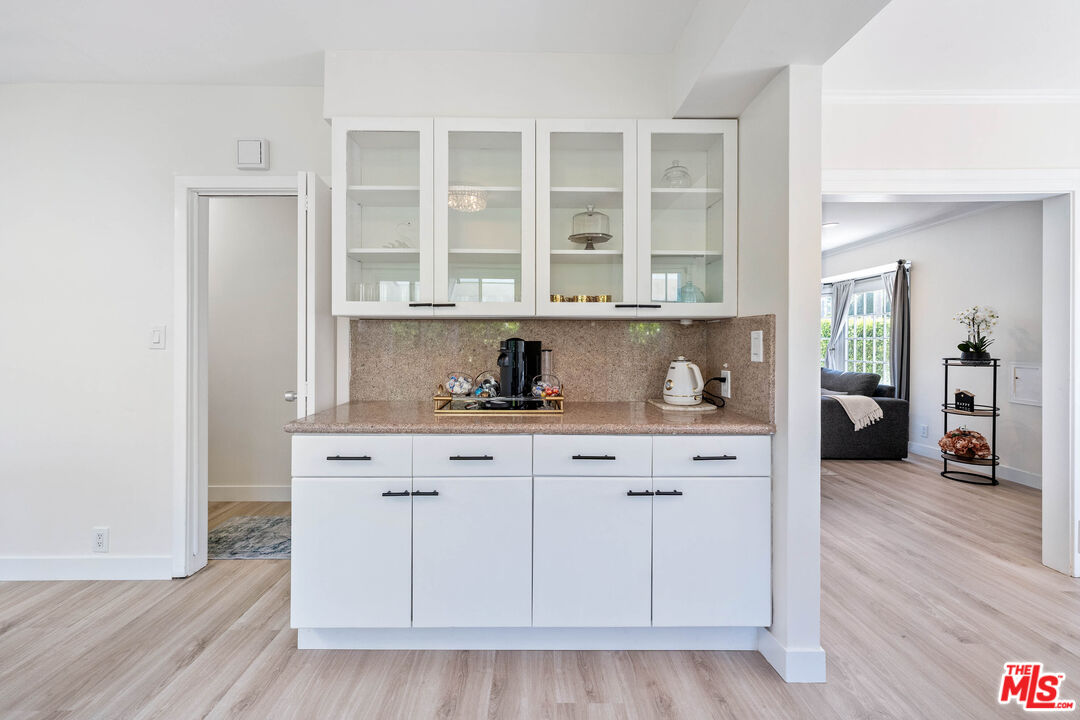 140 North Carson Road Beverly Hills, CA 90211 - Photo 8 of 28 a view of cabinets a wooden floor and a window