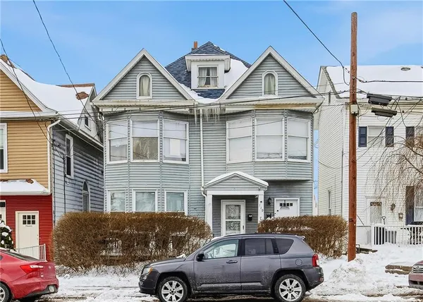 a front view of a house with parking space
