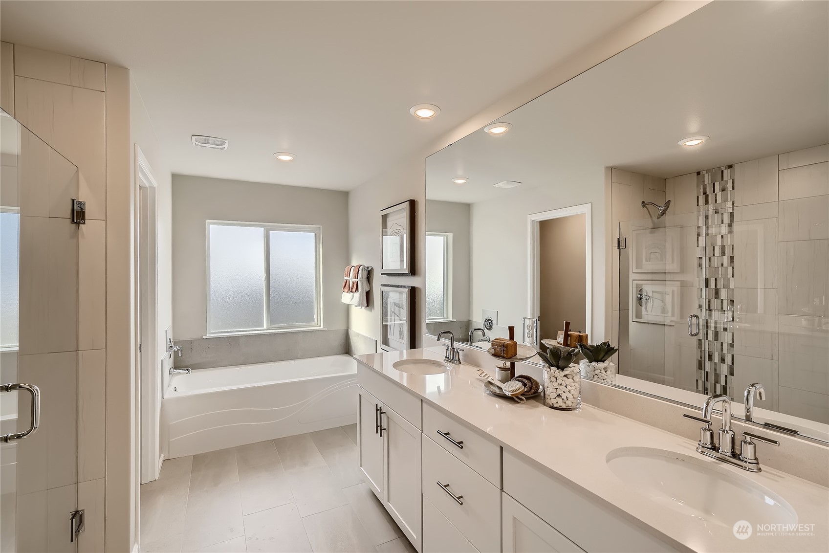 21029 42nd Avenue Southeast, Unit 116 Bothell, WA 98021 - Photo 18 of 22 a bathroom with double vanity sinks and a bathtub