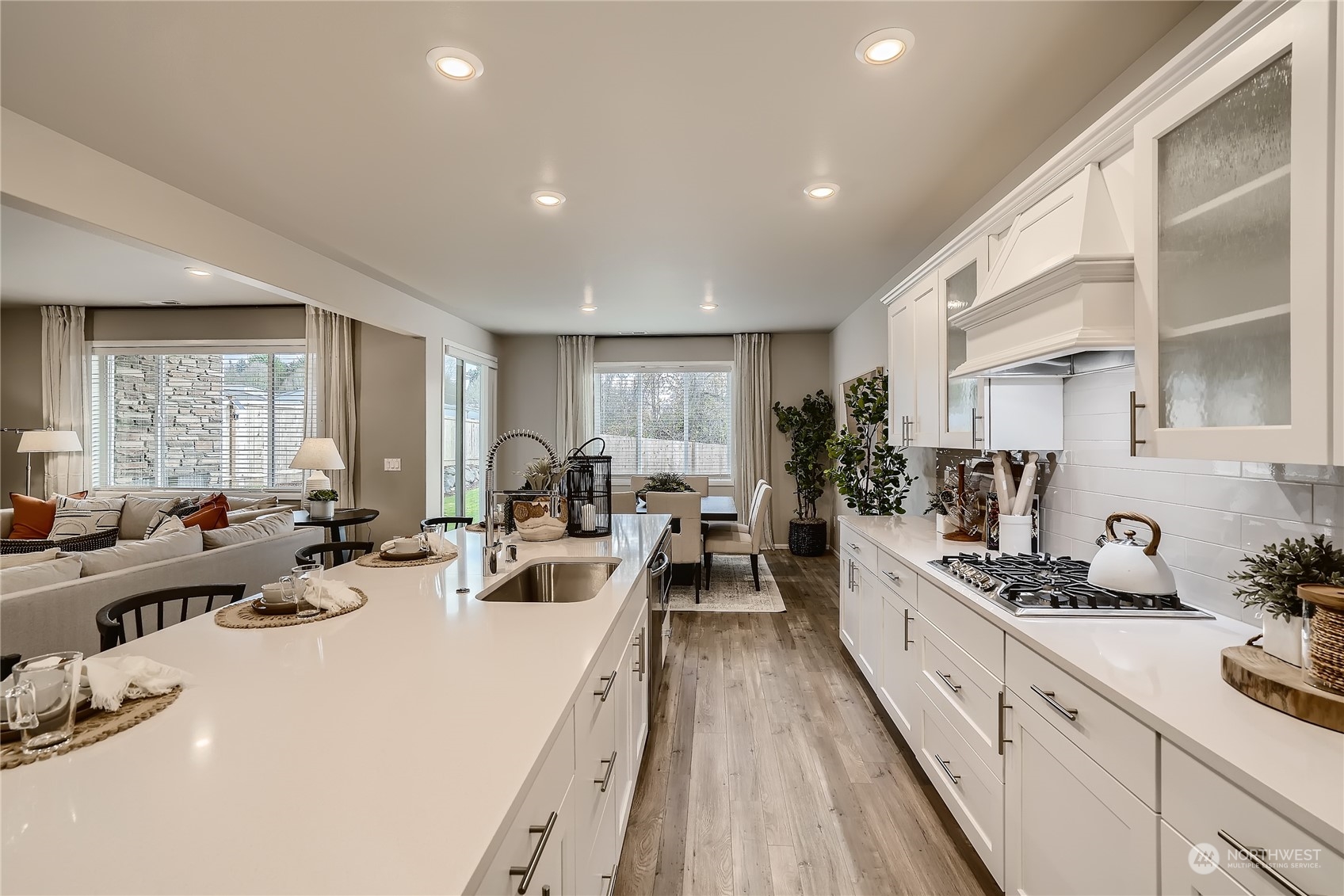 21029 42nd Avenue Southeast, Unit 116 Bothell, WA 98021 - Photo 5 of 22 a large room with kitchen island a large window cabinets a sink and stainless steel appliances