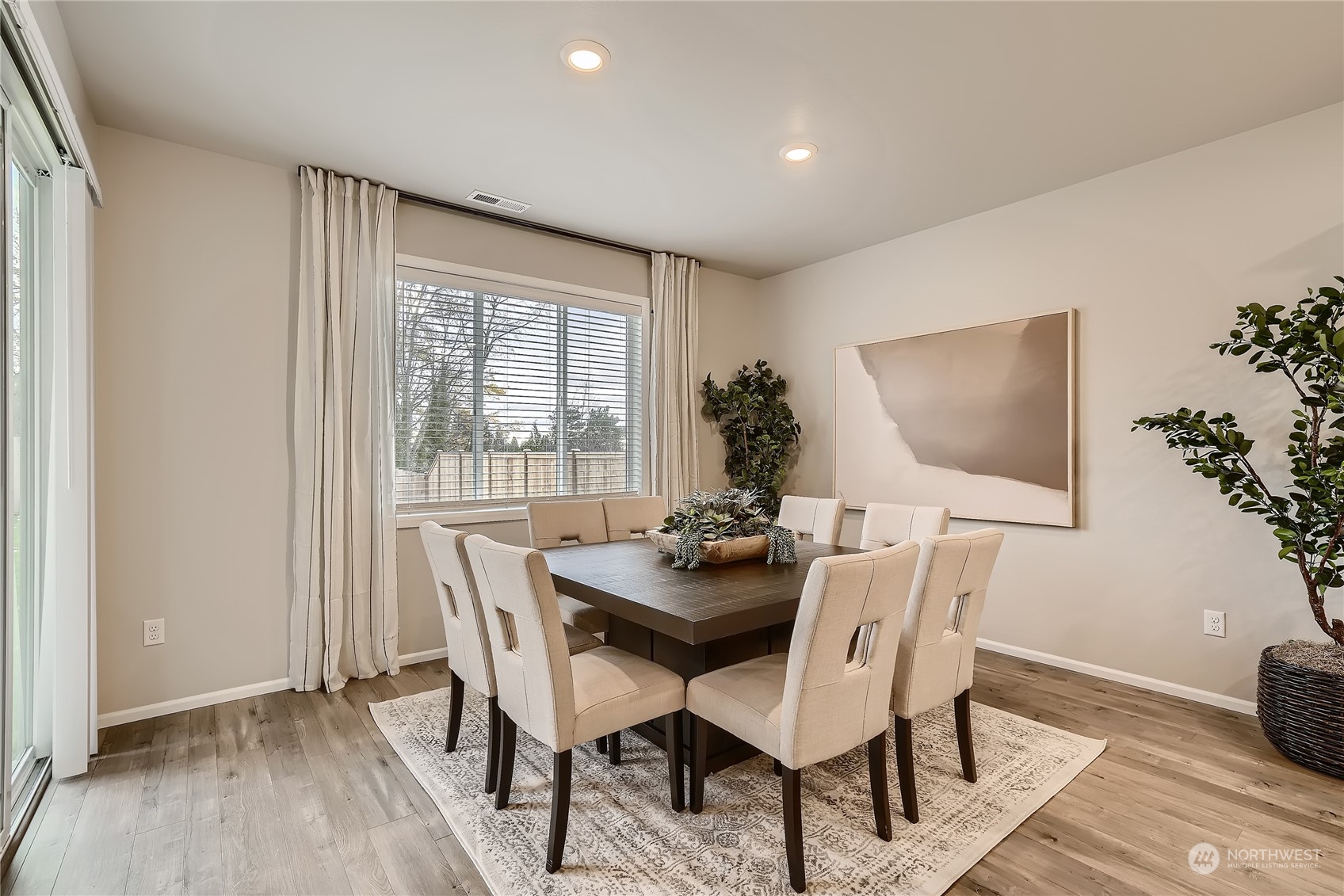 21029 42nd Avenue Southeast, Unit 116 Bothell, WA 98021 - Photo 9 of 22 a dining room with furniture potted plants and wooden floor