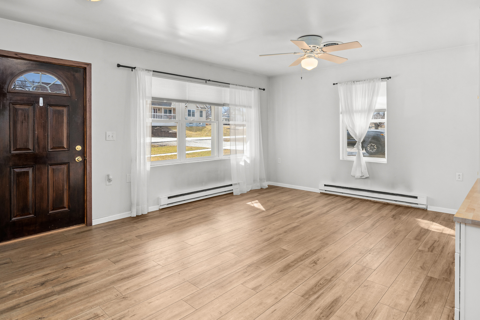 236 West Church Street Kewanee, IL 61443 - Photo 5 of 22 an empty room with wooden floor and windows