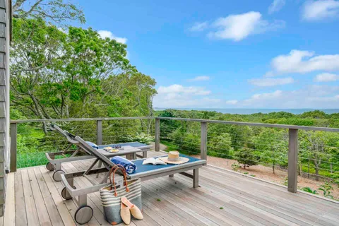 a view of a balcony with wooden floor and outdoor space