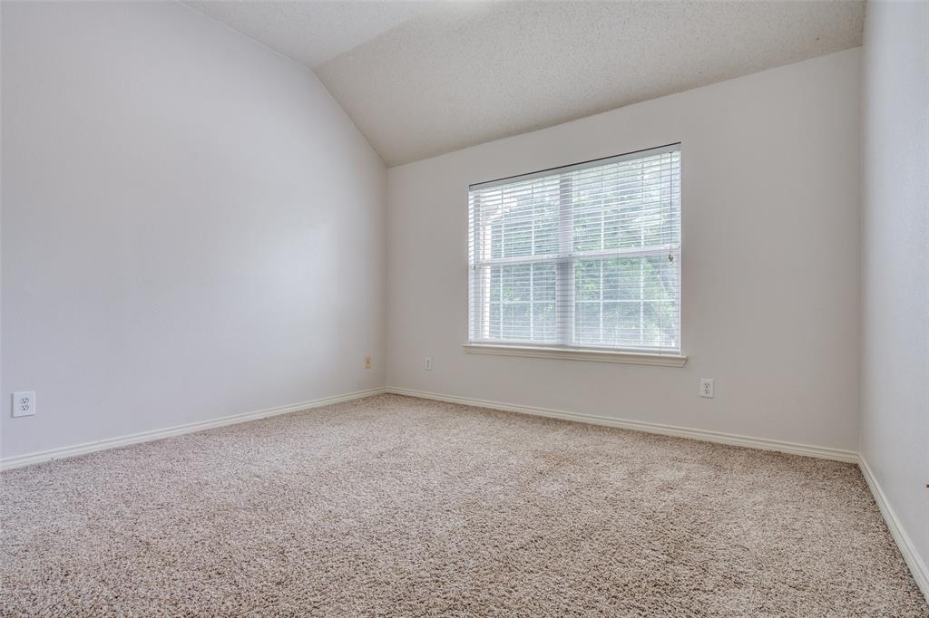 3421 Neiman Road Plano, TX 75025 - Photo 31 of 40 Carpeted spare room with vaulted ceiling and baseboards